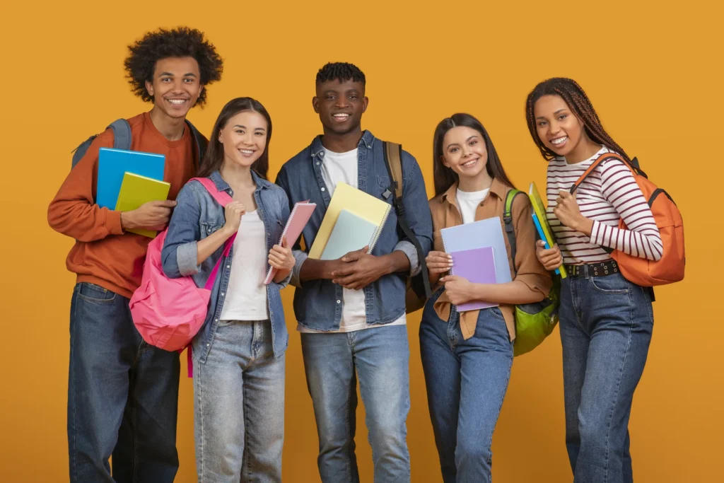 Students holding books in studio